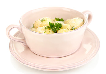 Tender young potatoes with sour cream and herbs in pan isolated