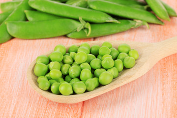 Sweet green peas on wooden background