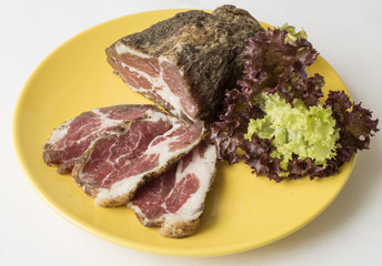 Corned pork, sprinkled with spices on a plate
