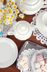 Table setting with chamomiles on wooden table