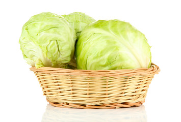 Fototapeta premium Green cabbage in wicker basket, isolated on white