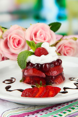 Tasty jelly dessert with fresh berries, on bright background