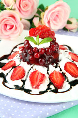 Tasty jelly dessert with fresh berries, on pink roses