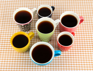 Many cups of coffee on checkered napkin