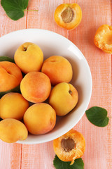 Naklejka na ściany i meble Apricots in plate on wooden table