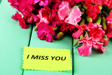 Bouquet of carnations, on color wooden background