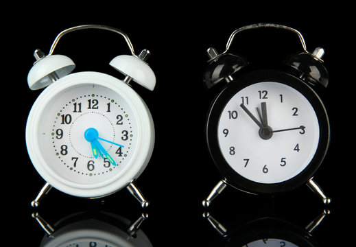 Two Old Style Alarm Clocks Isolated On Black