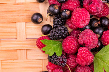 Fresh berries on a wicker backgound