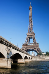 Fototapeta na wymiar Eiffel Tower and bridge on Seine river in Paris, France.