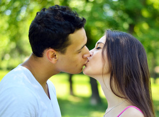 Fototapeta premium Young couple kissing outdoor