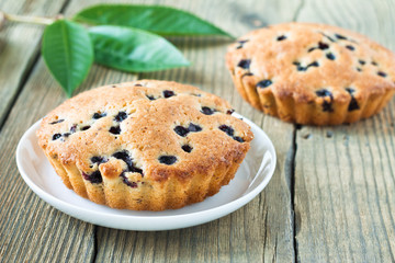 Homemade mini fresh blueberry pies on white plate