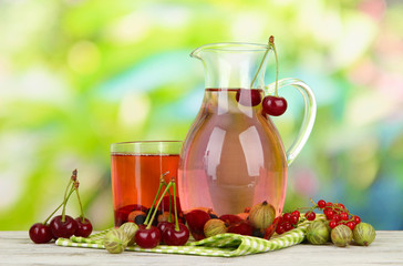 Pitcher and glass of compote with summer berries