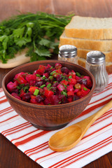 Beet salad in bowl on table close-up