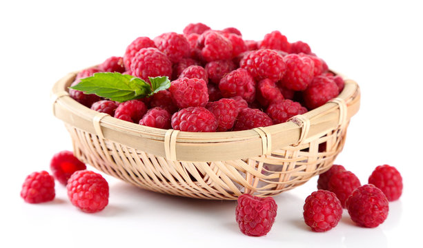 Ripe sweet raspberries in basket, isolated on white