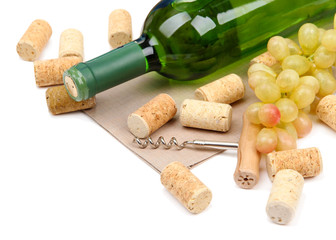 Bottle of wine, grapes and corks, isolated on white