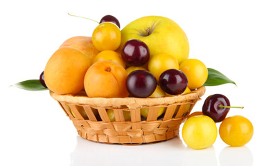 Bright summer fruits in basket isolated on white