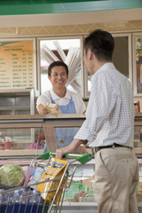 Sales Clerk assisting man at the Deli counter, Beijing