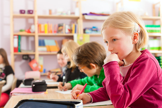 Schulkinder und Lehrerin lernen an der Schule