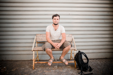stylish man sitting on a bench