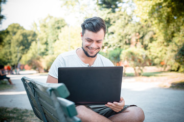 young stylish man using notebook