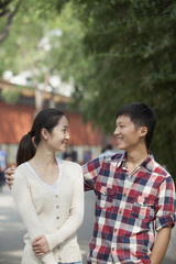 Young Chinese Couple Walking In Jing Shan Park