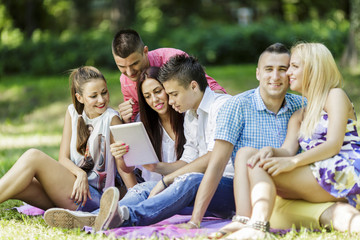 Teenagers in the park with tablet
