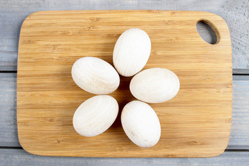 Fototapeta na wymiar Wooden ester eggs prepared for painting ornaments. Blank space,