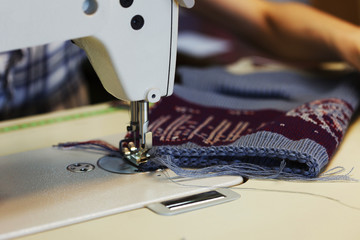 Work in sewing shop at textile factory, close-up