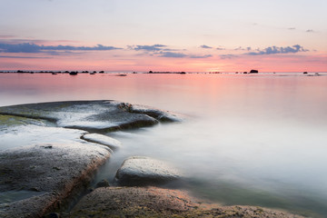 Sunset behind rocky coast