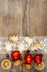Christmas cookies, apples and nuts on wooden table. Copy space
