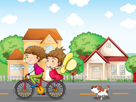 A boy and a girl biking followed by a dog