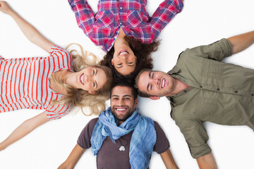 Friends lying in a circle and smiling at camera