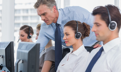 Manager helping call centre agent