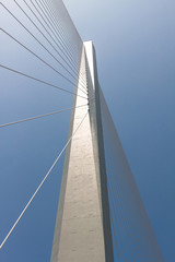 Fragment of a cable stayed bridge on the sky background.