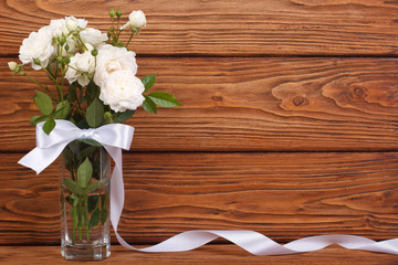 beautiful frame of the bouquet of white roses and a ribbon