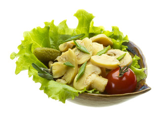 Marinated mushrooms in white saucer isolated on white