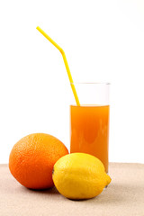 Juice, orange, lime on sand.
