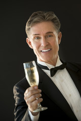 Happy Man In Tuxedo Toasting Champagne Flute