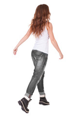 back view of jumping  woman  in  jeans.
