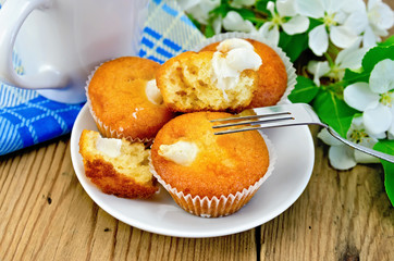 Cupcakes with sweet cream on a plate