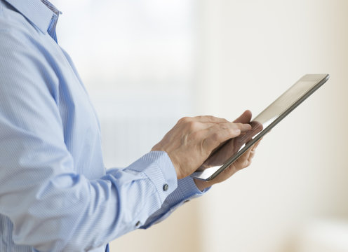 Businessman Using Digital Tablet - Powered by Adobe