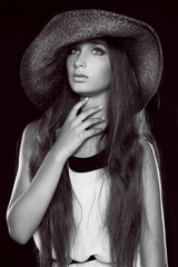 Fashion portrait of beautiful  woman posing in hat, black and wh