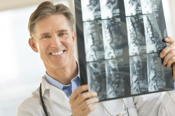 Confident Male Doctor With X-Ray Image