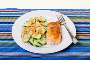 Dinner of Salmon and Cucumbers on Colorful Placemat