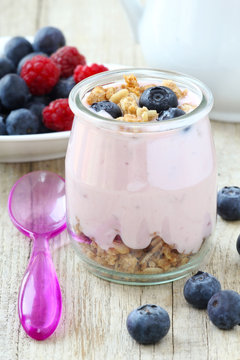 Healthy breakfast of natural yogurt with muesli and blueberries