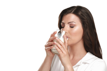 young beautiful woman drink a glass of milk
