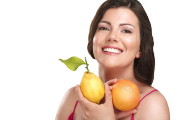 young beautiful woman showing fresh fruits of season