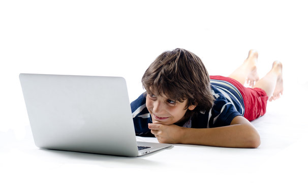 Child on the floor using laptop computer