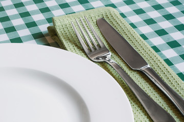 table setting on green Gingham table cloth