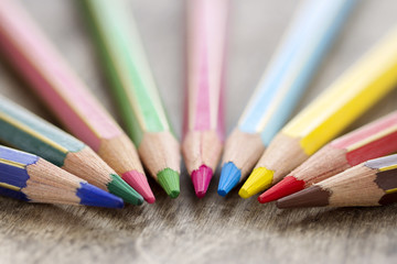 Fototapeta premium Colorful wooden color pencils on rustic background